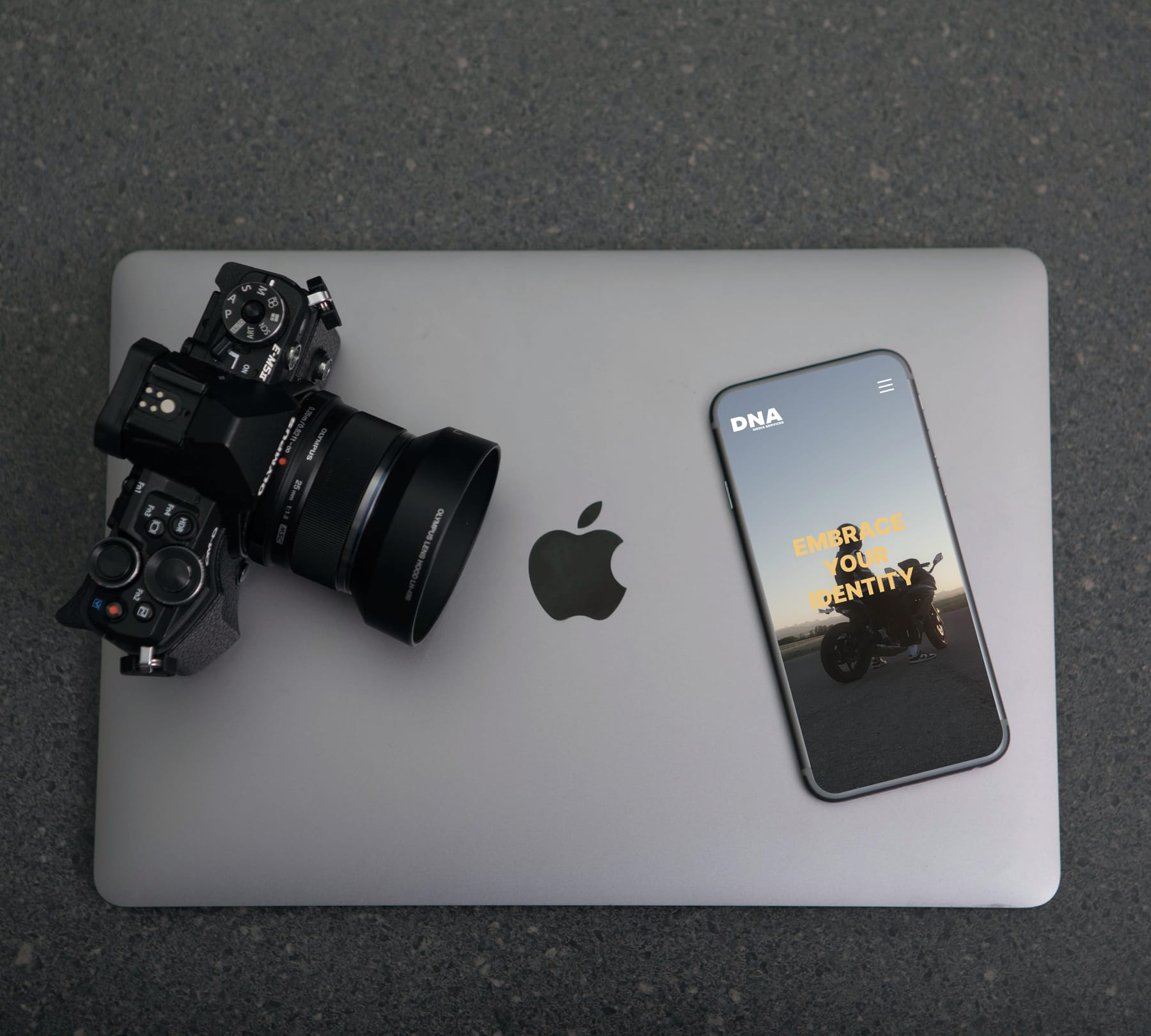 A camera and an iphone with DNA's website showing.
